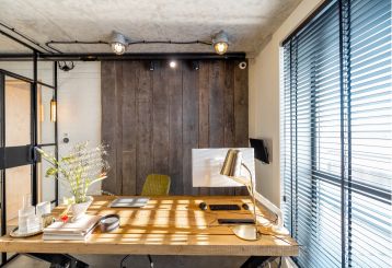 Mini blinds installed in a living room with a view of the outdoors