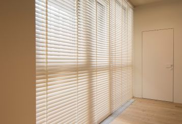 Elegant wooden blinds on a window with a view.